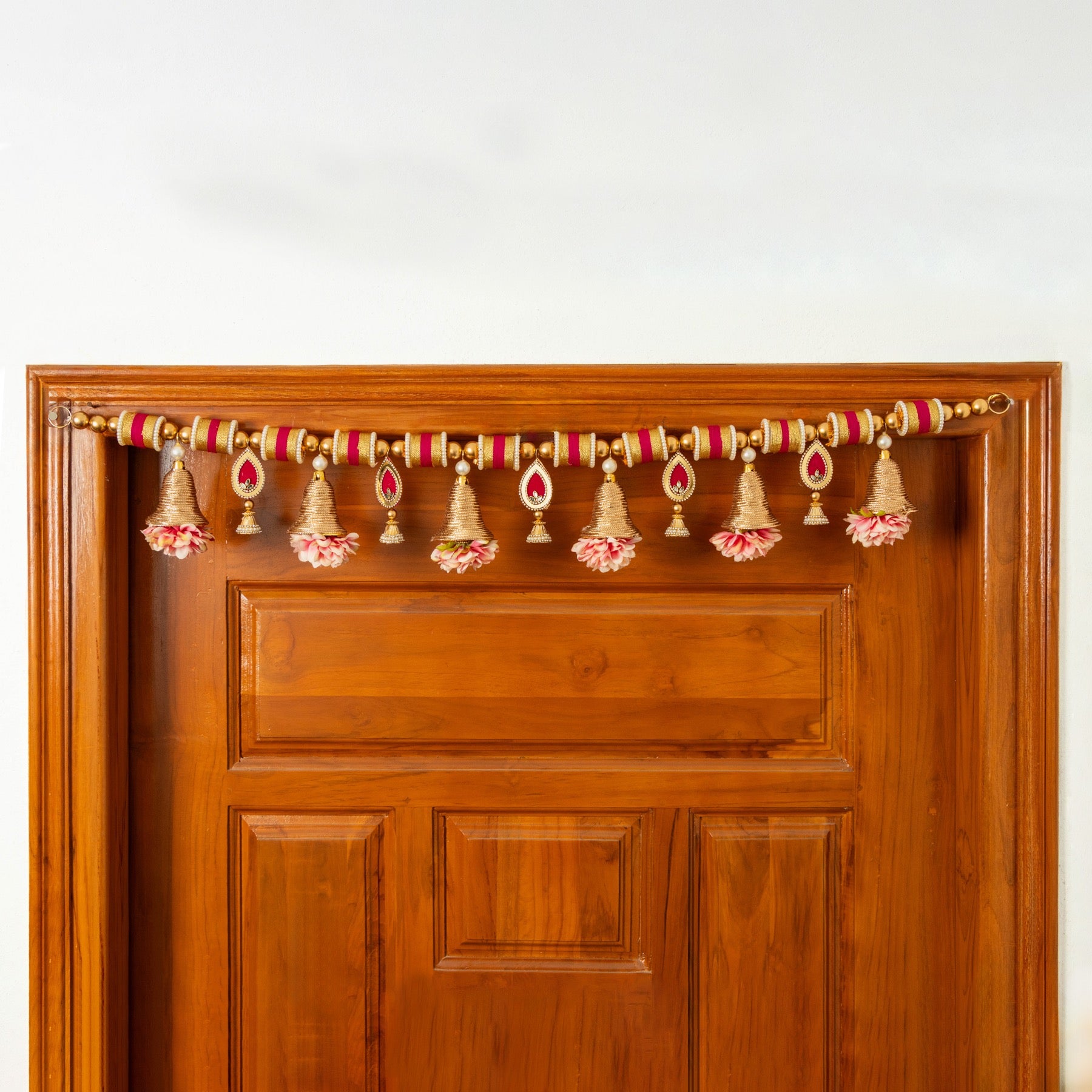 Handcrafted Golden Bell & Pink Floral Toran with Beaded Accents