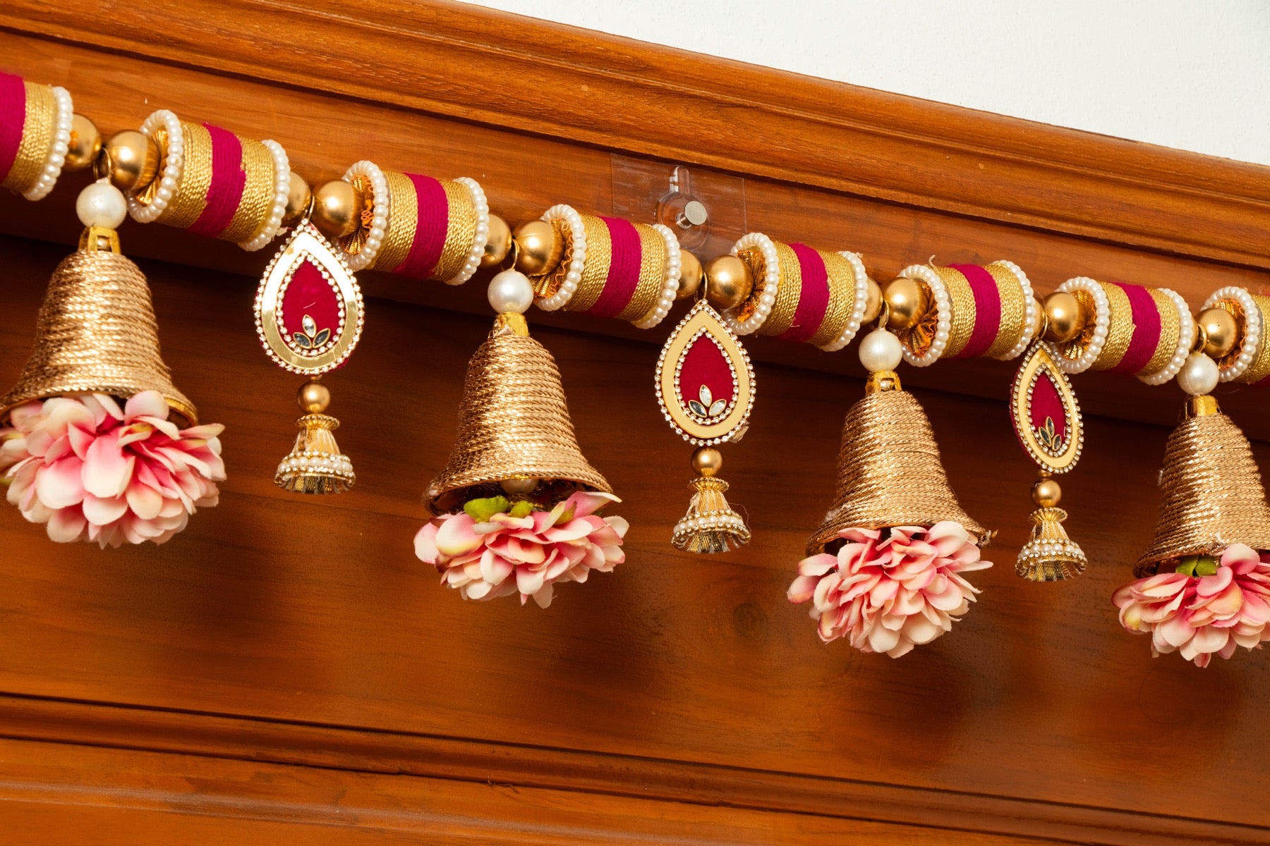 Handcrafted Golden Bell & Pink Floral Toran with Beaded Accents